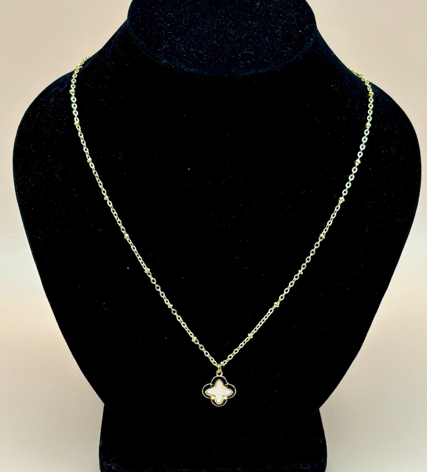 #149 Gold-Filled Clover Leaf Mother of Pear Outlined in Black Lacquer on Gold-Filled Chain.